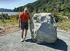 Small photograph of heavy equipment handling a large boulder.